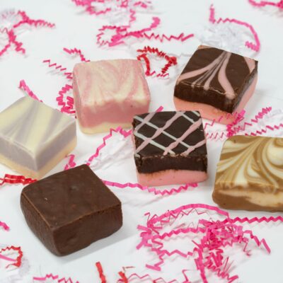 4oz pieces of Mother's Day Fudge from left to right: Lemon Lavender, Chocolate, Strawberry Champagne, Dark Chocolate Raspberry Truffle, Chocolate Amaretto, Cappuccino.