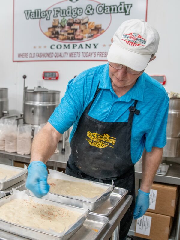 Steve Schulte putting the finishing touches on a pan of fudge in the production area.