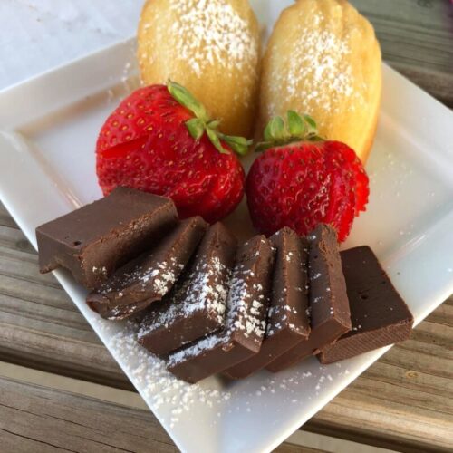 Chocolate Fudge Presentation with strawberries, powdered sugar and pastries.
