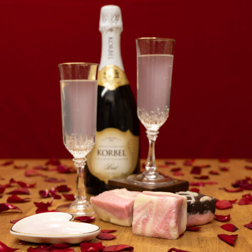 Strawberry Champagne Fudge Valentines Display with Champagne glasses and bottle.